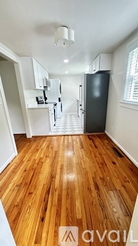 A kitchen with a refrigerator and a staircase.
