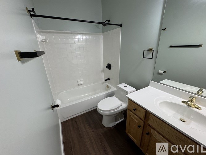 A bathroom with a toilet, sink, and bathtub.