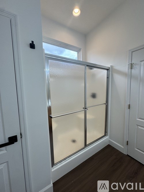 A white door with a glass panel is closed.