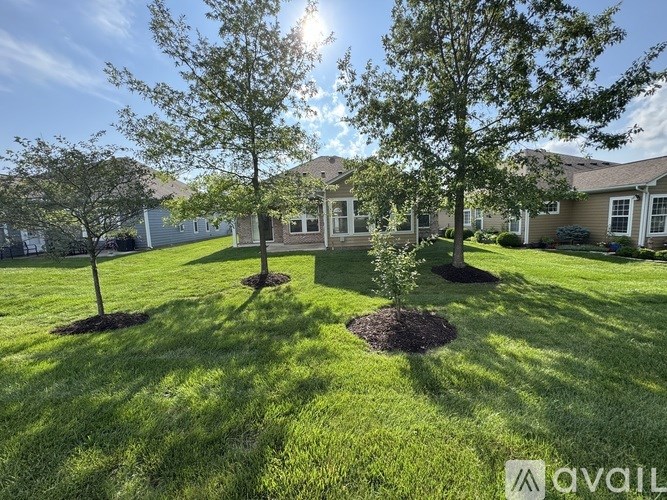 A sunny day at a residential area with houses and green lawns.