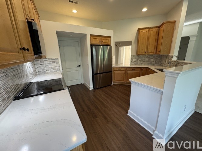 A kitchen with wooden cabinets and a white countertop.