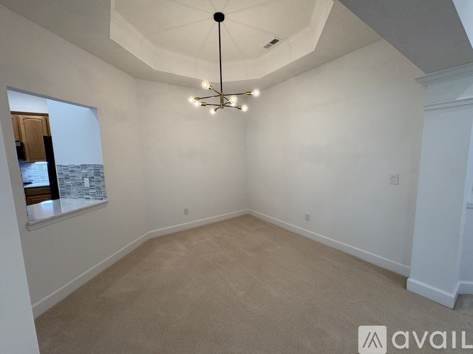 A room with a large window and a view of a cityscape.