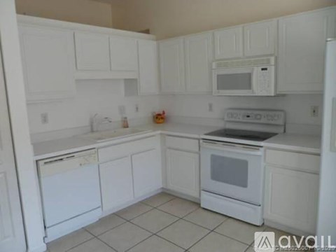 A white kitchen with a dishwasher and oven.