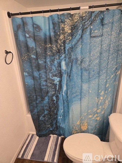 A view from inside a room looking out onto a balcony with a wooden railing.