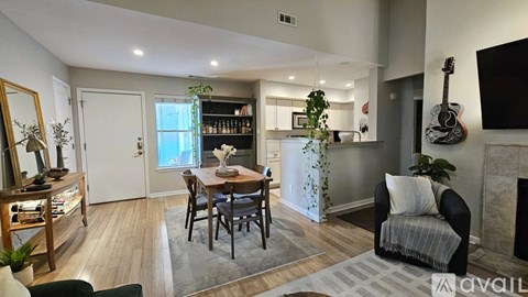 A living room with a dining table and chairs.