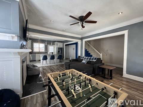 A foosball table is in the middle of a living room.