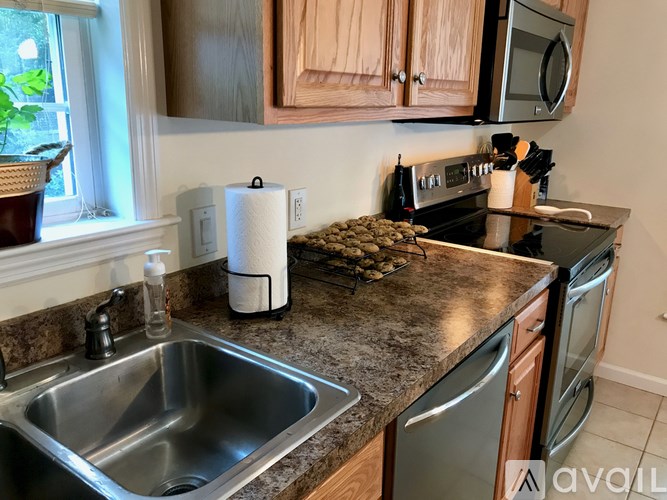 A kitchen with a sink, toaster, and oven.
