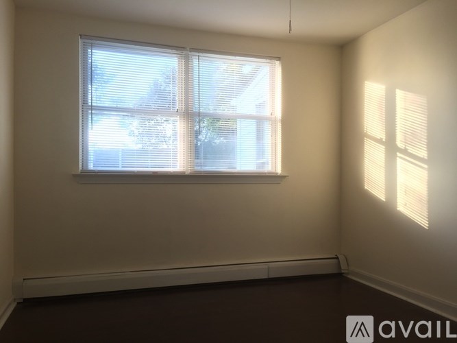 A room with a window and a wall with a logo that says "AVAIL".