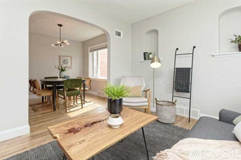 A living room with a dining table and chairs.