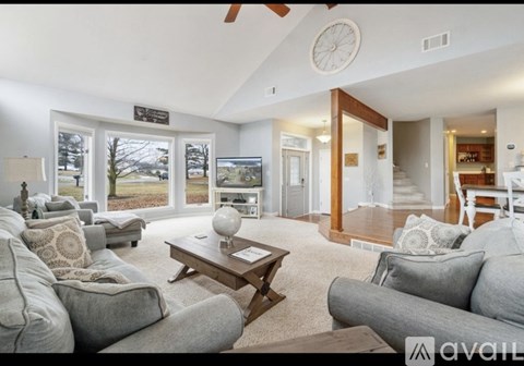 A living room with a grey couch and a wooden coffee table.