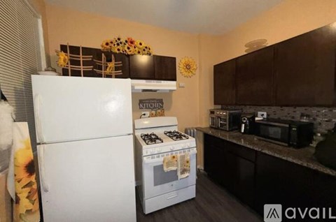 A kitchen with a white fridge and a white stove top oven.