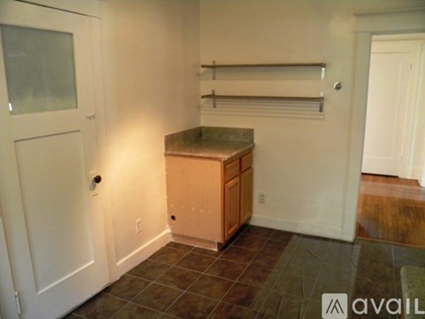 A kitchen area with a counter and cabinets.
