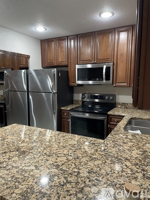 A kitchen with granite countertops and stainless steel appliances.