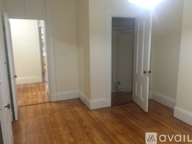 A room with wooden floors and white walls.