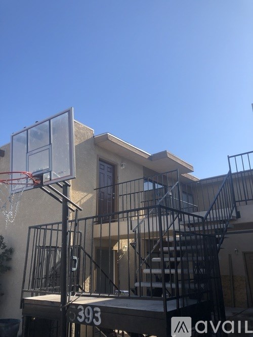 A basketball hoop is attached to the side of a building.