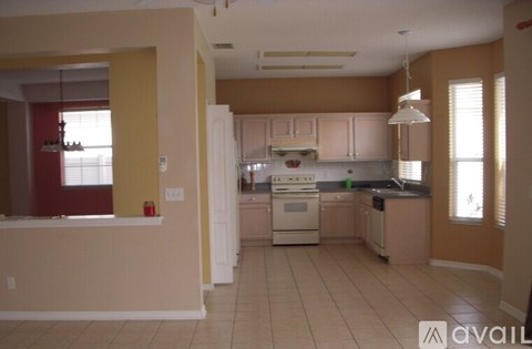 A kitchen with a white stove top oven and a white refrigerator.