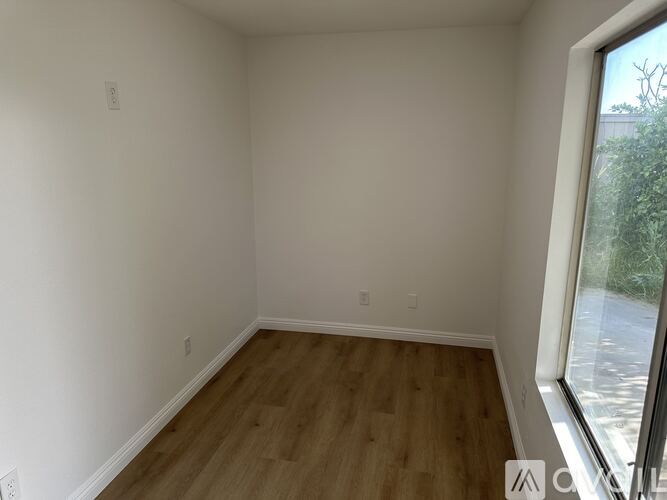 A room with a door and a sign that says $850/month.