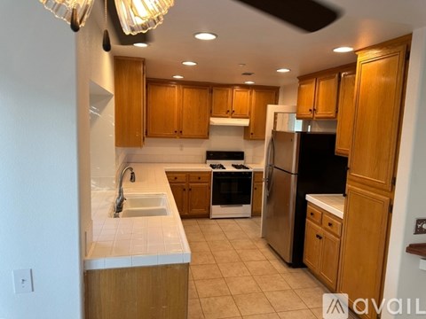 A kitchen with wooden cabinets and stainless steel appliances.