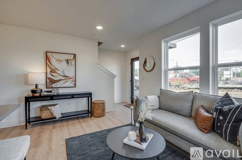 A living room with a grey couch and a coffee table.