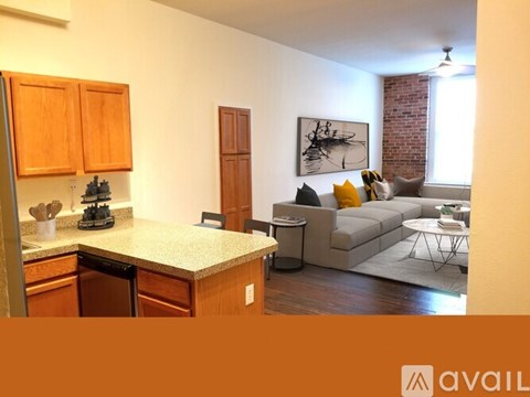 A kitchen with wooden cabinets and a countertop with a few utensils on it.