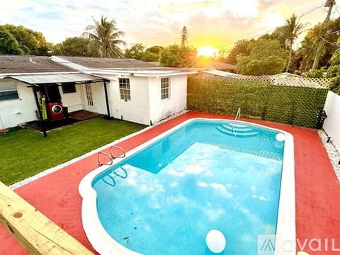 A small pool in a backyard with a red border.