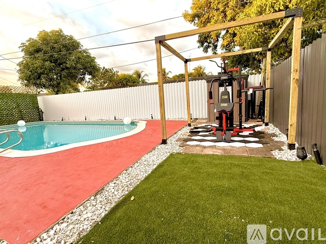 A backyard with a pool and a playground.
