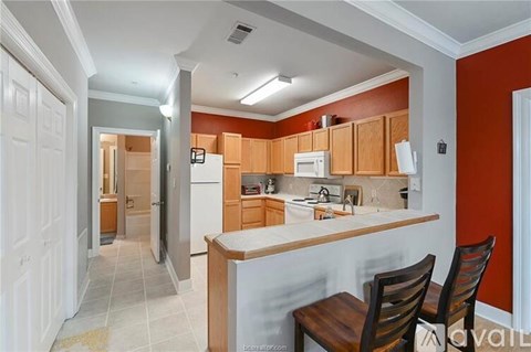 A kitchen with wooden cabinets and a white refrigerator.