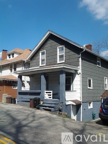 A two-story house with a grey exterior and a white trim.