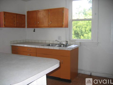 A kitchen with wooden cabinets and a white countertop.