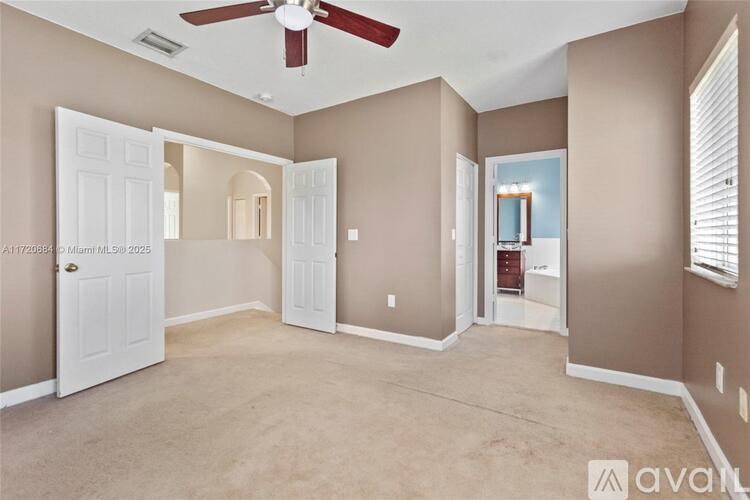 A room with a fan and a door.