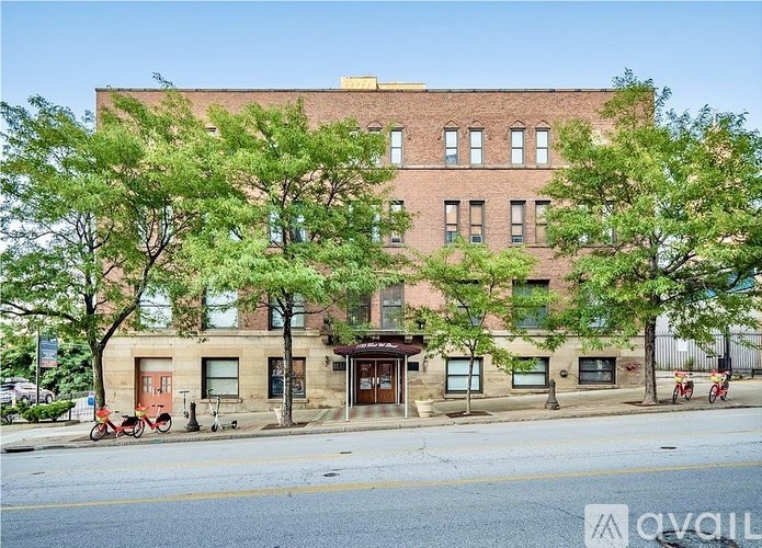 A building with a red bicycle parked in front of it.