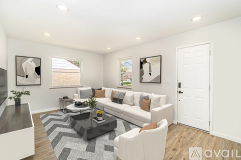 A living room with a white couch and a coffee table.