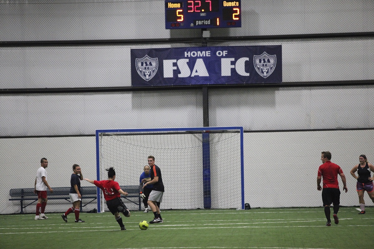 a group of young men playing soccer on a field
