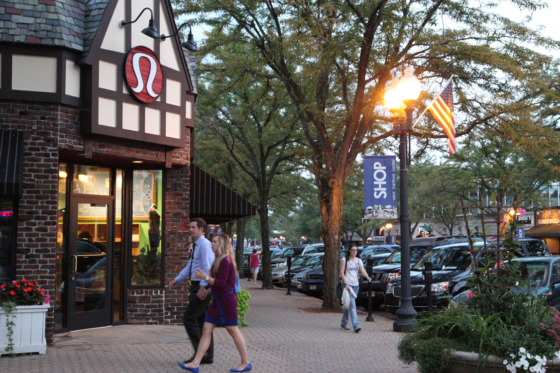 Couple walking along shops