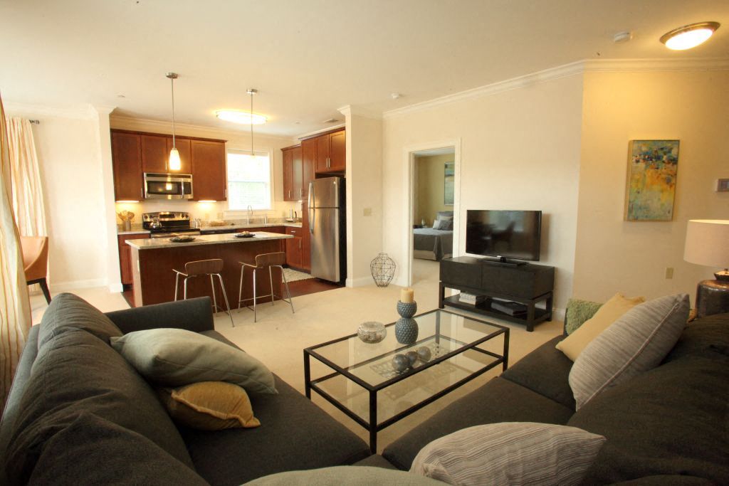 a living room with a couch and a glass table