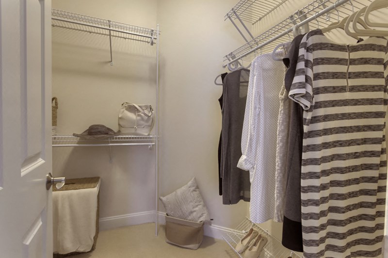 a walk in closet with a shower and some towels