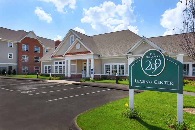 a large building with a leasing center sign in front of it
