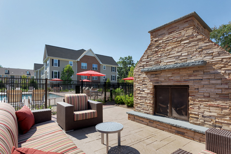 our apartments have a large patio with furniture and a fireplace
