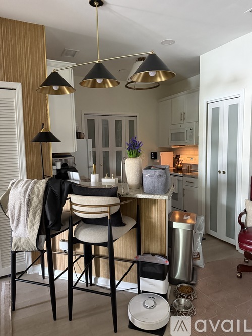 A kitchen with a dining table and chairs.