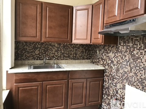 A kitchen with brown cabinets and a sink.