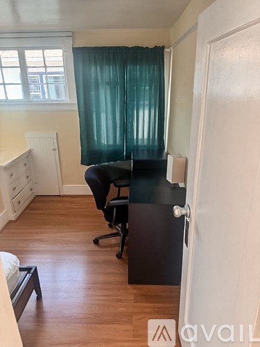 A room with a desk and a chair.