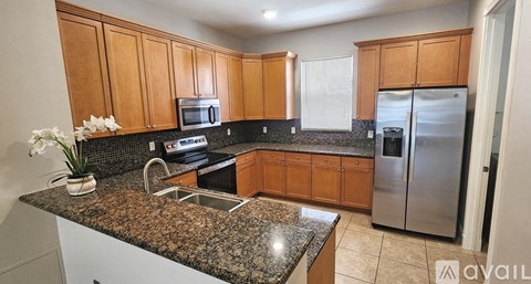 A kitchen with granite countertops and stainless steel appliances.