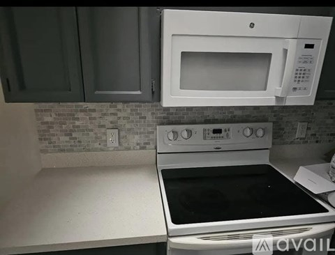 A white oven and microwave in a kitchen.