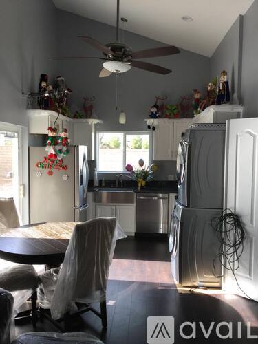 A kitchen with a table and chairs and a fridge with a Christmas decoration on it.