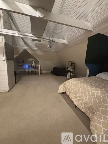 A bedroom with a bed and a ceiling fan.