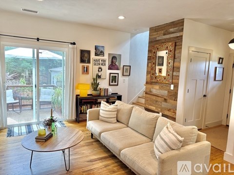 A living room with a white couch and a coffee table.
