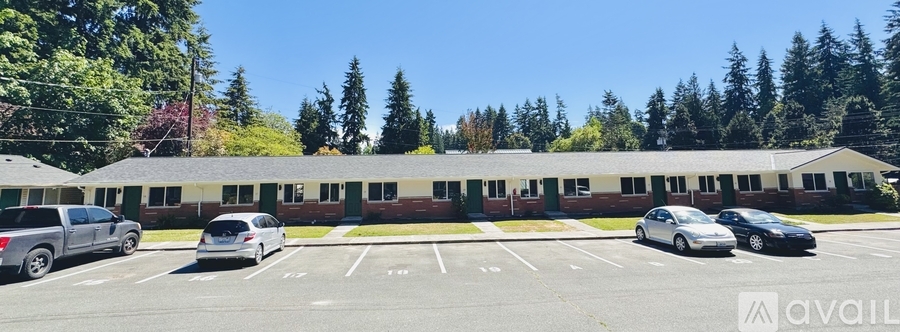 A parking lot with cars and a building in the background.