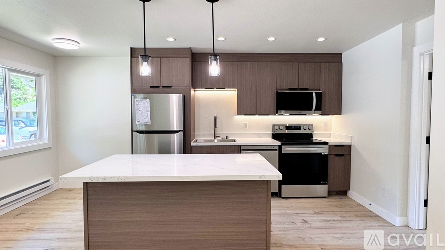 A kitchen with a white countertop and brown cabinets.