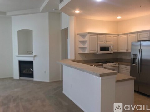 A modern kitchen with white cabinets and stainless steel appliances.