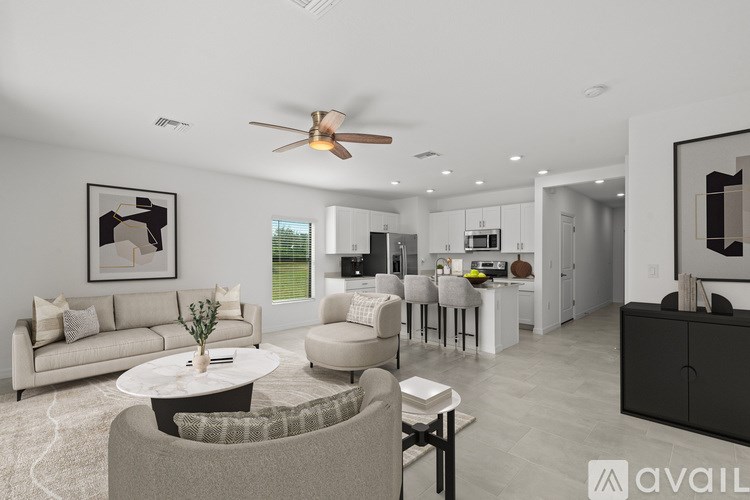 A modern living room with a grey sofa, a coffee table, and a ceiling fan.